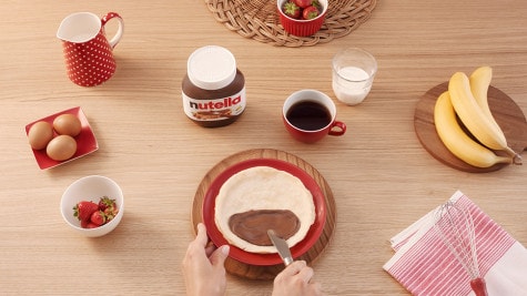 Assembling Nutella jar spa gift with oils and labels, step three.