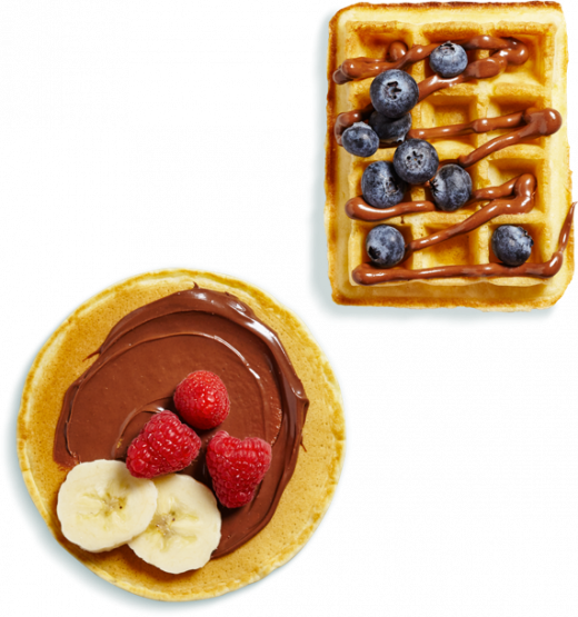 Pancake stack and waffle drizzled with Nutella and topped with berries.
