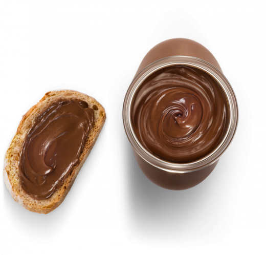 Sliced bread with open Nutella jar and spread on slice, breakfast setup.