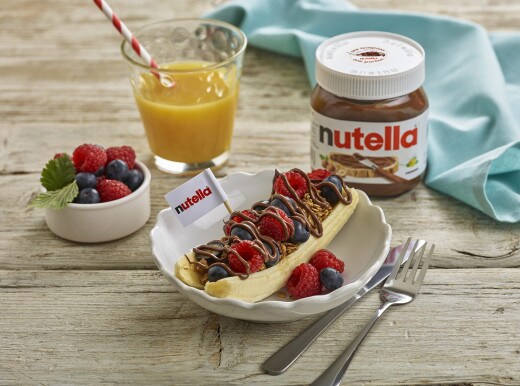 Banana split 'sailing boats' with Nutella, ice cream and fruit garnish.