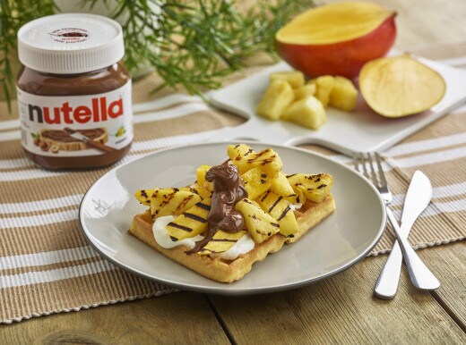 Pineapple and mango waffle topped with Nutella and fresh tropical fruit.