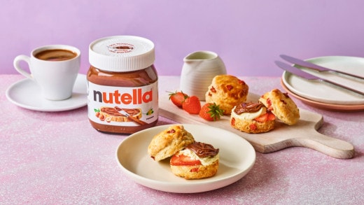 Delicious breakfast scones with strawberries, whipped clotted cream, and Nutella®, served with tea and coffee.
