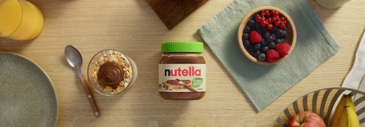 Plant-based Nutella occasion banner featuring jar, pancakes and fruit.