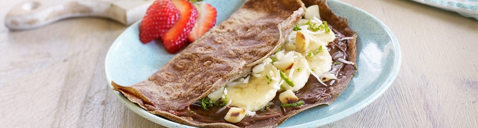 Buckwheat crepes filled with Nutella and toasted hazelnuts, folded.