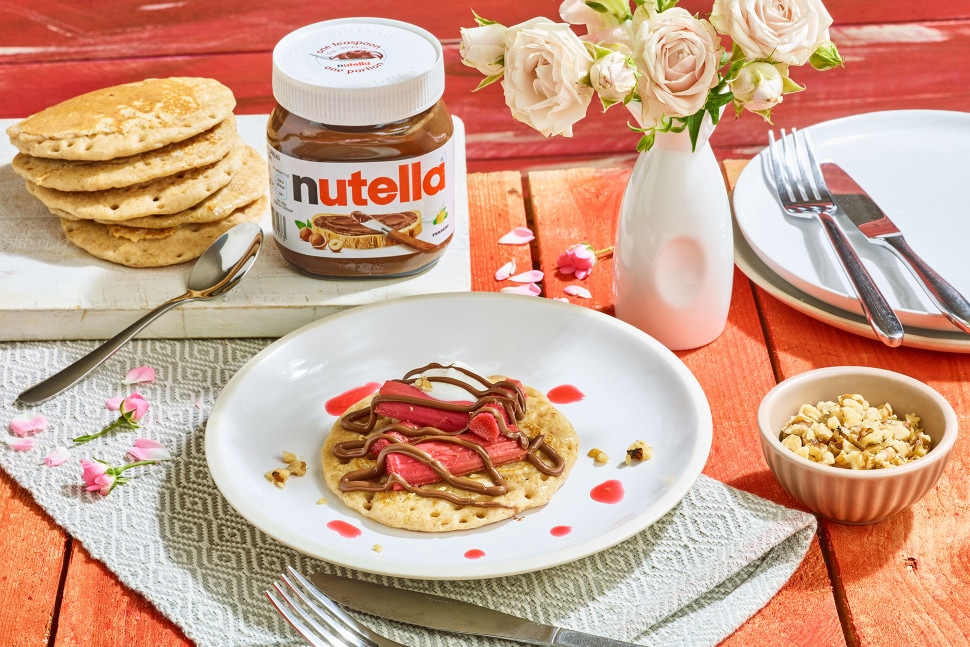 Rhubarb pikelets drizzled with Nutella and served with cream.
