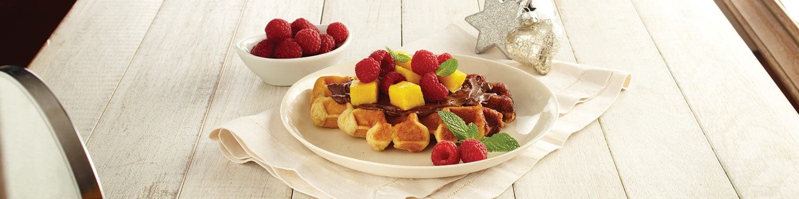 Waffles with Nutella® hazelnut spread, Mango and Raspberries
