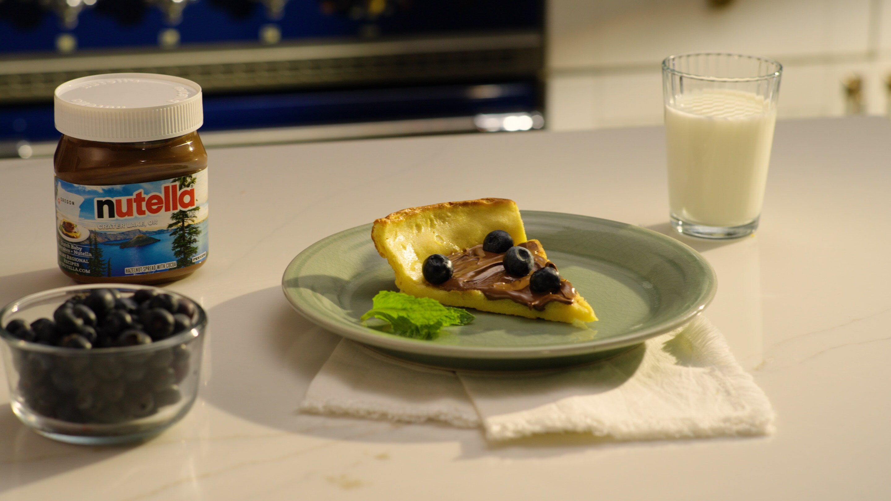 Dutch baby pancakes topped with Nutella, powdered sugar and fruit