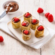 Mini raspberry crepe bites filled with Nutella, dusted with icing sugar