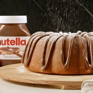 Bundt cake topped with Nutella glaze on a holiday table.