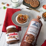 Rice cake decorated like a reindeer with Nutella details.