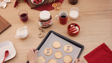 Christmas note cookies decorated with Nutella and festive icing.