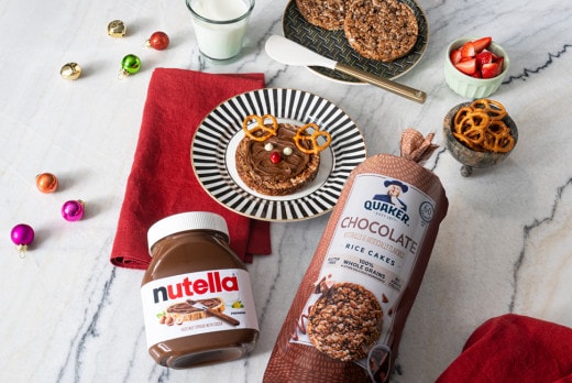 Rice cake decorated like a reindeer with Nutella details.