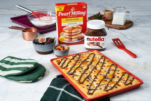 Sheet pancake drizzled with Nutella and topped with berries.